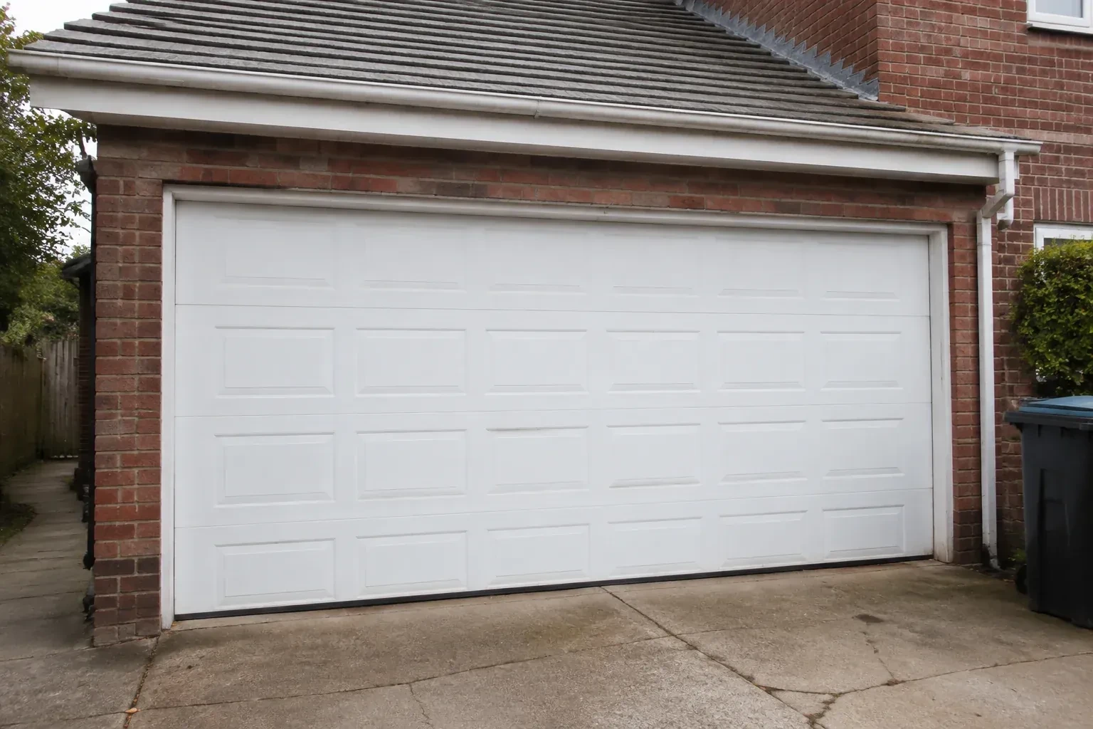 Closed white sectional garage door at an ordinary brick house. — Sectional Garage Door Replacement, Vaughan